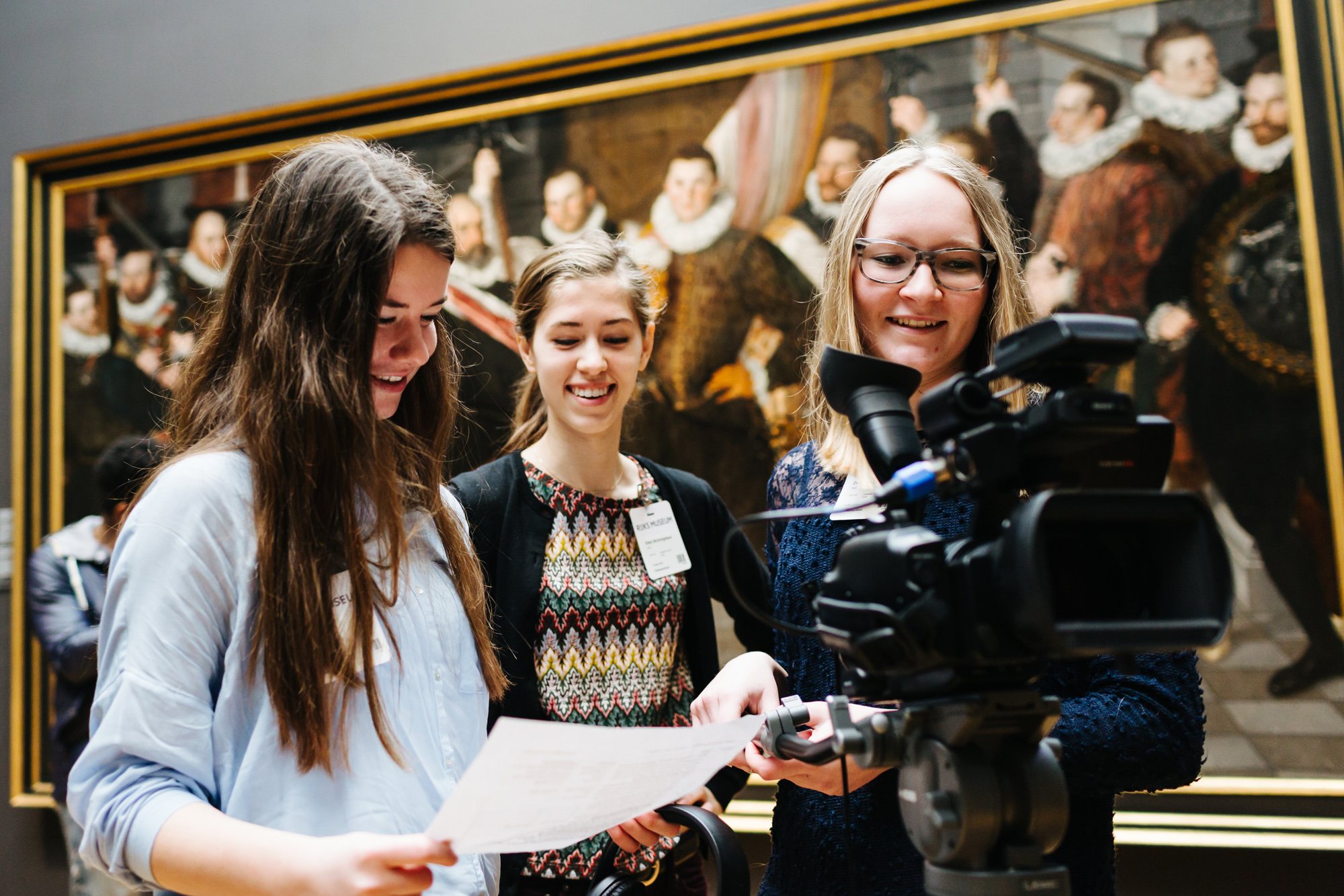 3 students in the museum with a camera